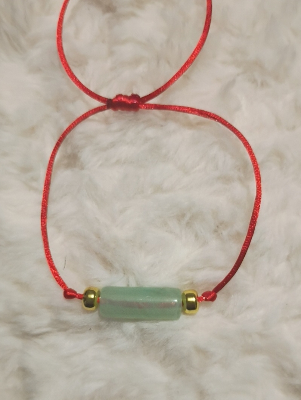 Adjustable Red Cord Bracelet with Light Green Bead and Gold Accents